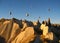 Royal ballons flying in the sunrise light in Cappadocia, Turkey above the Fairy ChimneysÂ rock formationÂ nearby Goreme